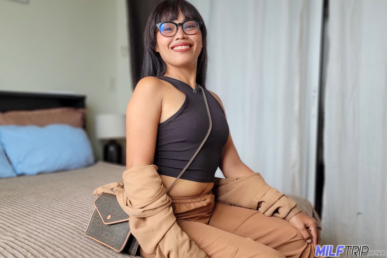 Glamorous Asian milf poses and starts to strip in a Manila hotel